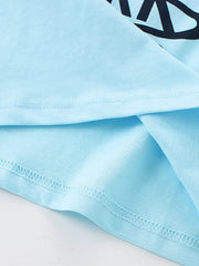 Close-up hem detail showing pastel blue fabric stitching and a folded edge