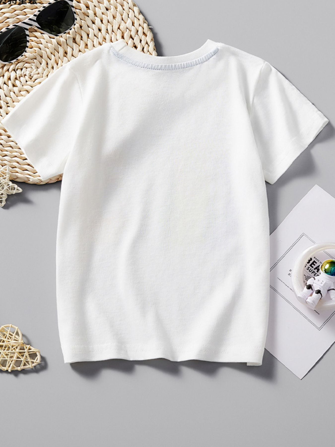 Plain back view of a white children's casual T-shirt laid flat with no graphic