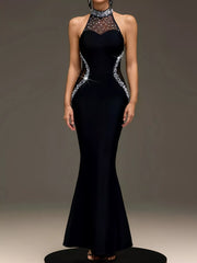 Straight front view of black sleeveless maxi dress with pearl trim on platform
