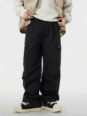 Men's black cargo pants with wide legs and pockets.