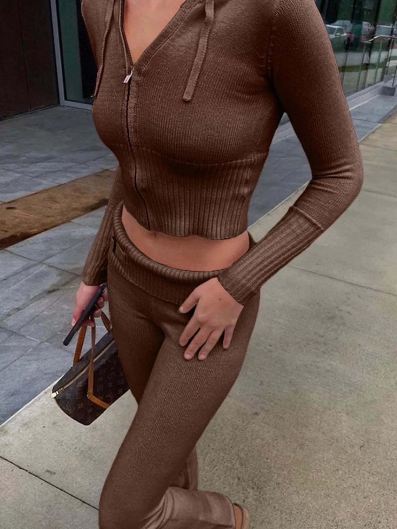 Brown ribbed zip up hooded cardigan and matching pants worn on city street