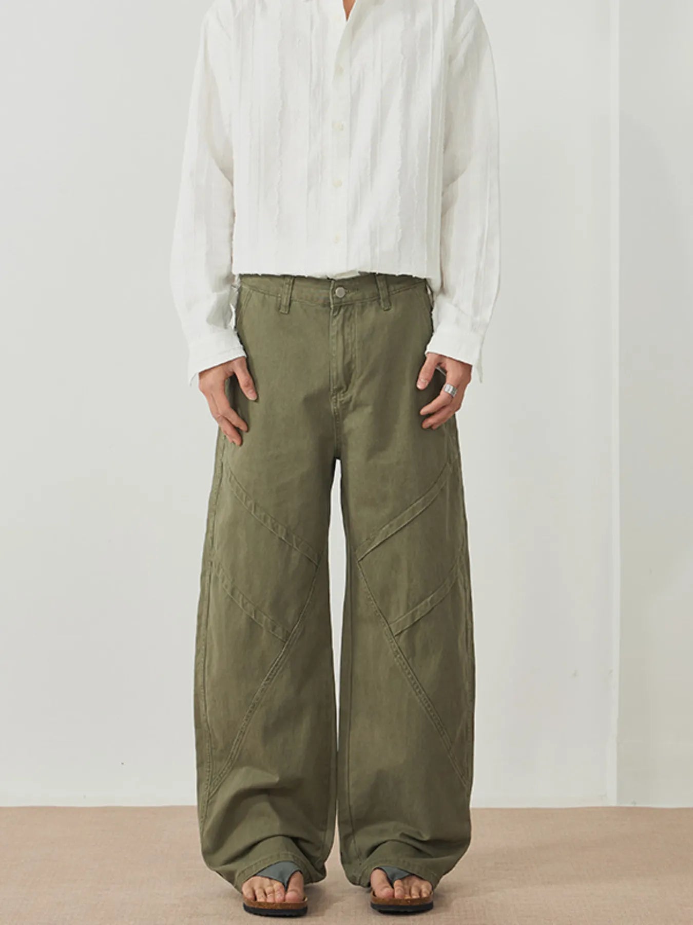 Men's army green wide-leg pants with an oversized fit and pockets.