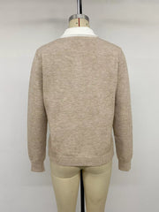 Back view of the solid beige argyle sweater with a white collar on a mannequin