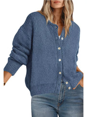 Front view of haze blue button down cardigan with white buttons worn with blue jeans