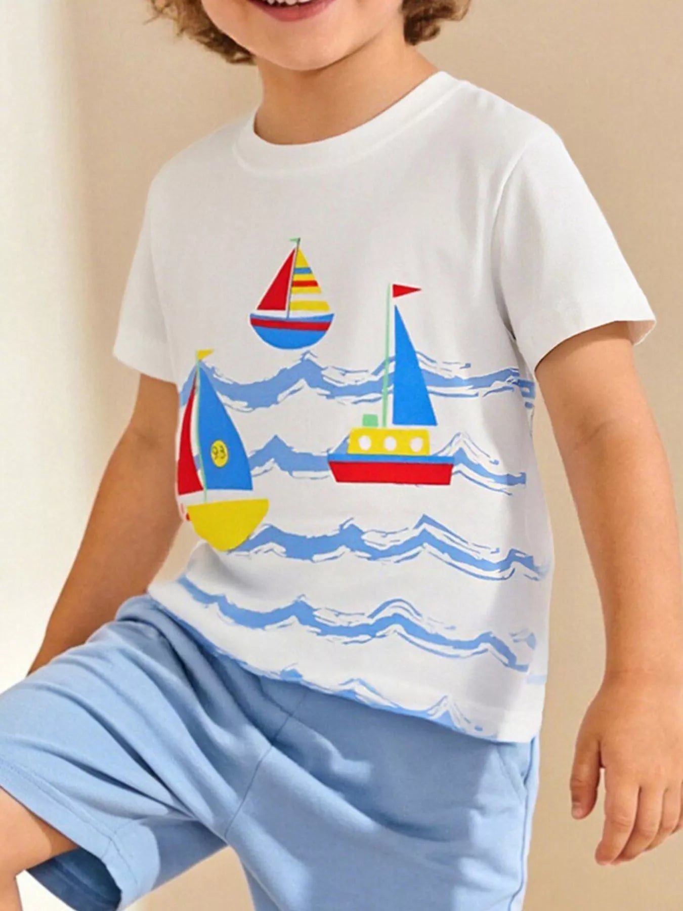 Children's white crew-neck T-shirt featuring a nautical sailboat print.