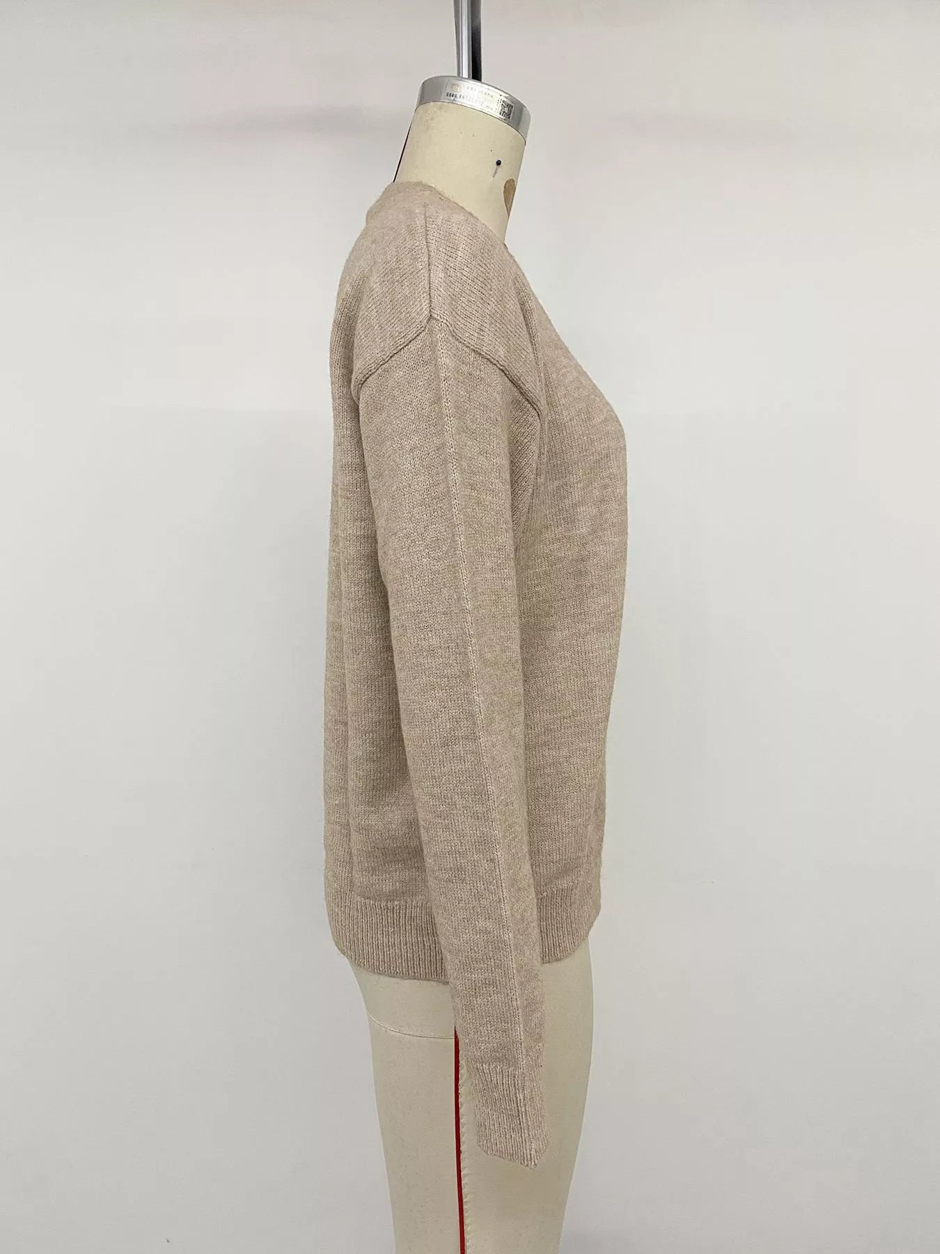 Side view of khaki dropped shoulder long sleeve sweater on mannequin