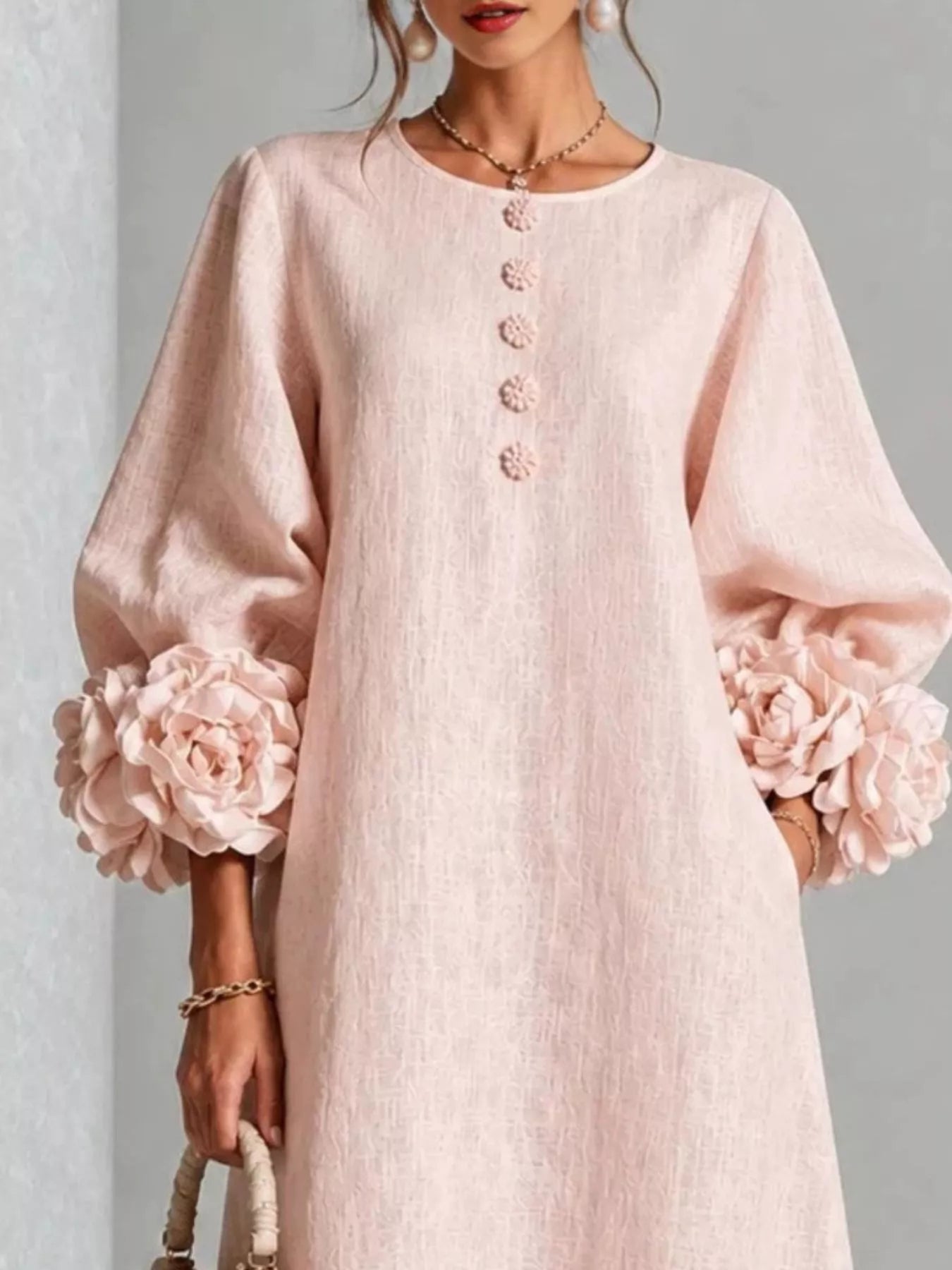 Close front view of the watermelon pink round neck midi dress bodice with small floral buttons