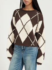 On-model front view of a brown and cream argyle knit sweater with dropped shoulders