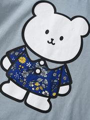 Close-up of white bear graphic wearing a blue floral shirt on light blue children's t-shirt