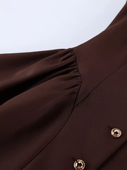Brown button down mini dress detail showing gathered waist seam and gold button