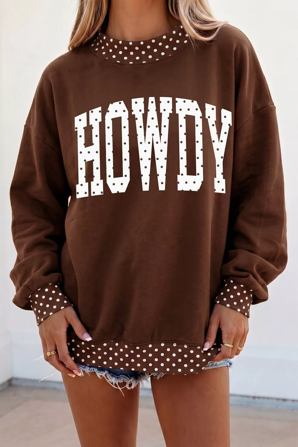 Brown sweatshirt with white polka dot HOWDY lettering and polka dot trim, front view