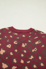 Close-up of the deep red leopard print knit top back neckline