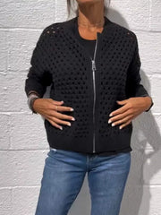 Front view of a black openwork crochet cardigan with a full front zip