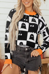 Front view of a black and white checkerboard sweater with ghost pattern and orange trim
