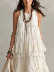 Upper bodice view of white sleeveless maxi dress showing layered ruffle tiers and pleated fabric