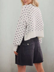Back view of the white bow print sweater with dropped shoulders and ribbed hem