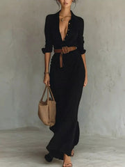 Front view of a black button front long sleeve shirt maxi dress with a brown belt