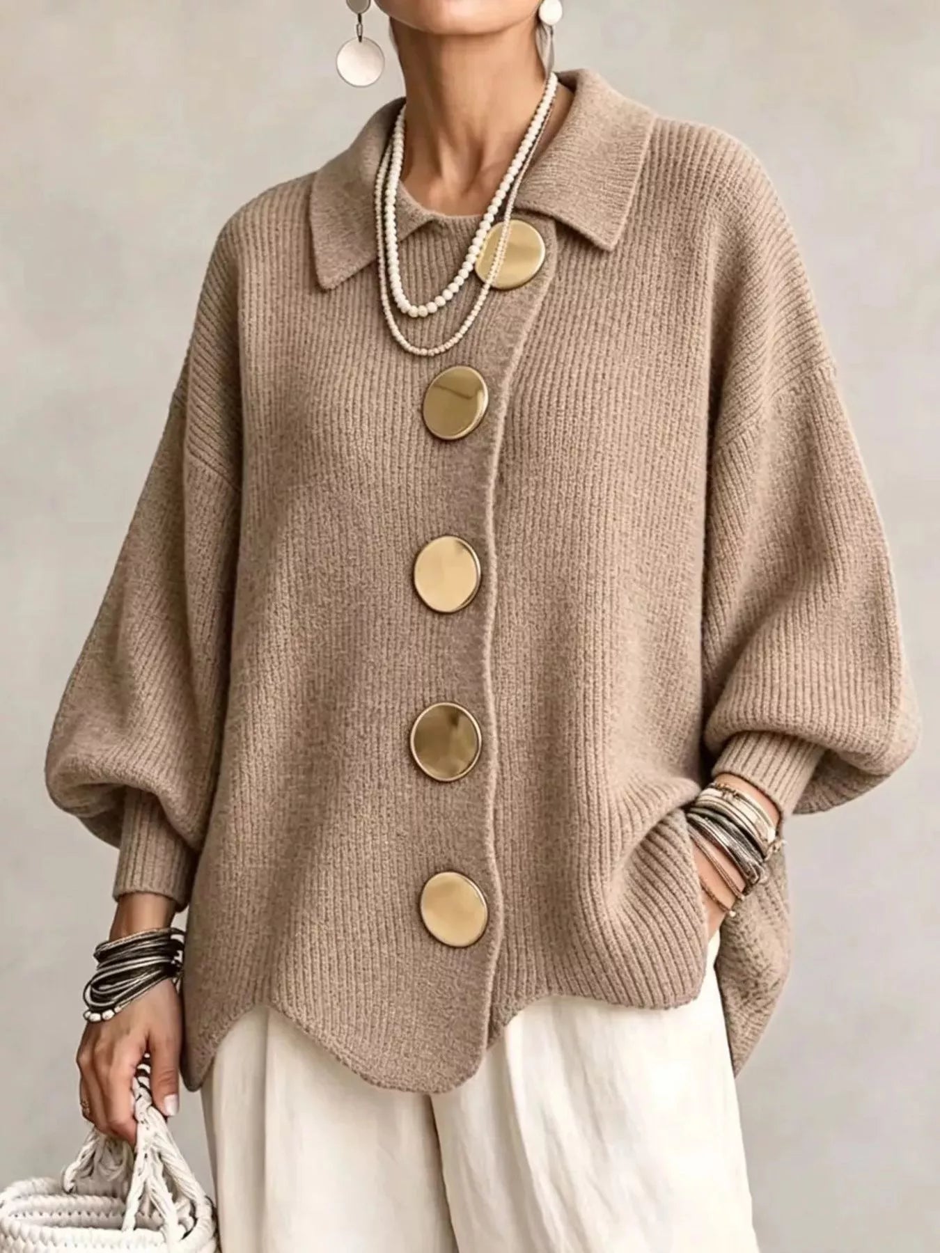 Front view of a khaki knit cardigan with large gold buttons and lantern sleeves