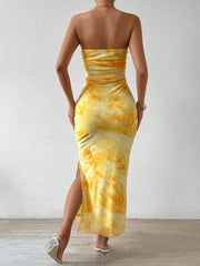 Back view of yellow ruched strapless bodycon midi dress with side slit