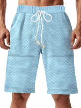 Men's light blue textured shorts with a drawstring waist and pockets.