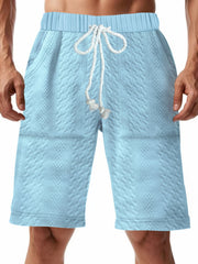 Men's light blue textured shorts with a drawstring waist and pockets.