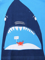 Close up of dark blue shark mouth print with small red crab on sky blue children's t-shirt