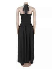 Back view of black halter maxi dress on a mannequin with smocked bodice and tie neck