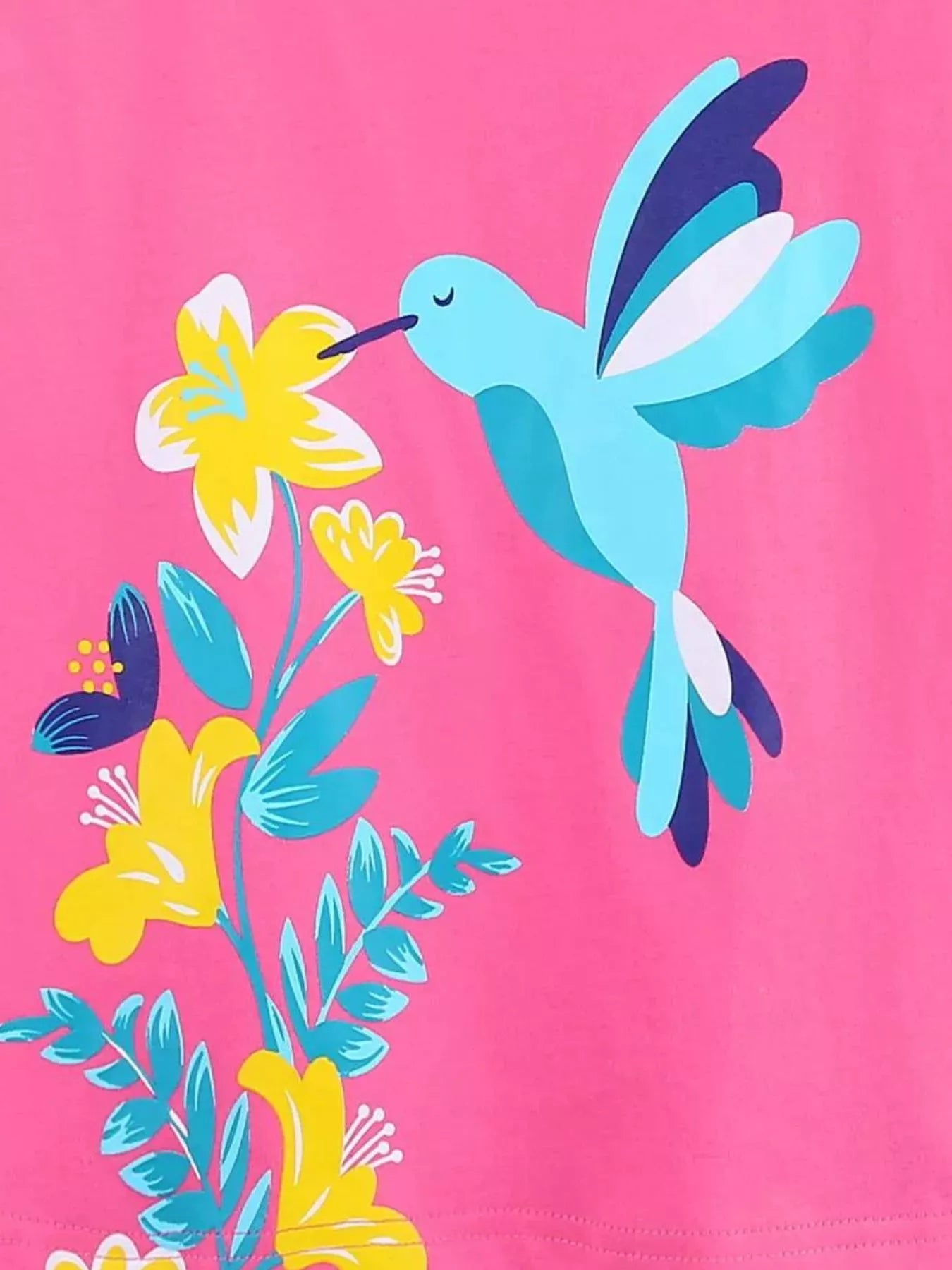 Close-up detail of the hummingbird and yellow flowers on hot pink fabric