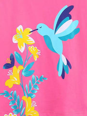 Close-up detail of the hummingbird and yellow flowers on hot pink fabric