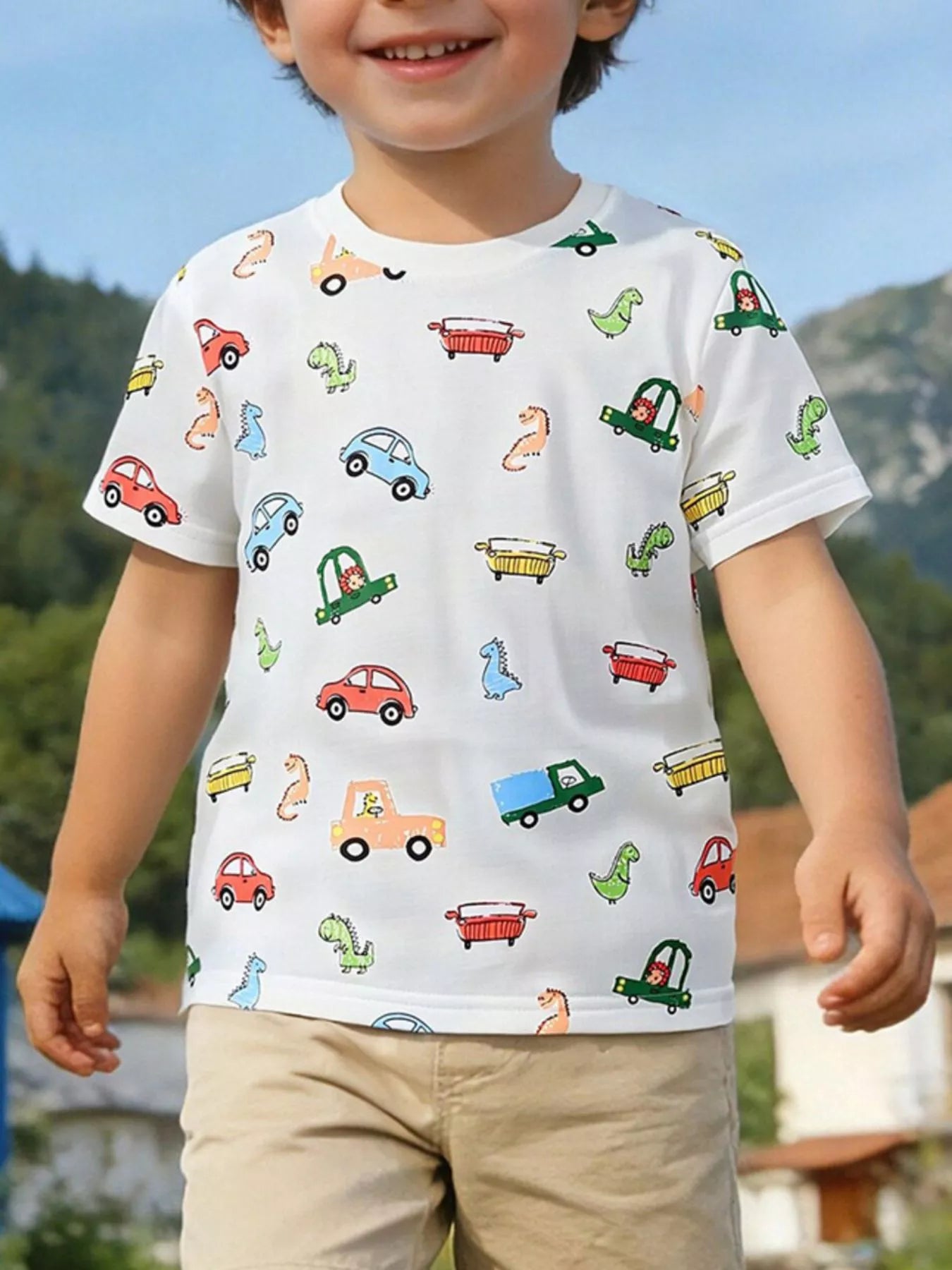 Children's white crew-neck T-shirt featuring a cartoon car and dinosaur print.