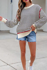 Full-length on-model front view of the striped oversized sweater worn with denim shorts