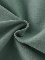 Close-up texture of the soft sage fabric of the children's short sleeve shirt