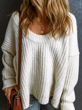 Front view of white slouchy chunky ribbed knit sweater with wide round neckline and long sleeves.