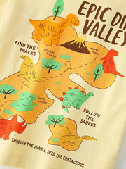 Close up of the dinosaur valley map with dinosaurs, a volcano and a dashed trail on a pale yellow tee