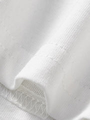 Close-up of the white fabric and hem stitching detail on a children's casual T-shirt