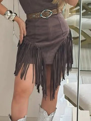 Close view of the waist, belt and fringe hem of a brown bodycon mini dress