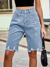 Women's denim shorts with raw hems in a non-stretch rayon blend.