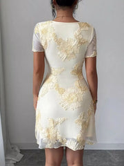 Back view on model of milky white floral mesh short sleeve mini dress with floral applique