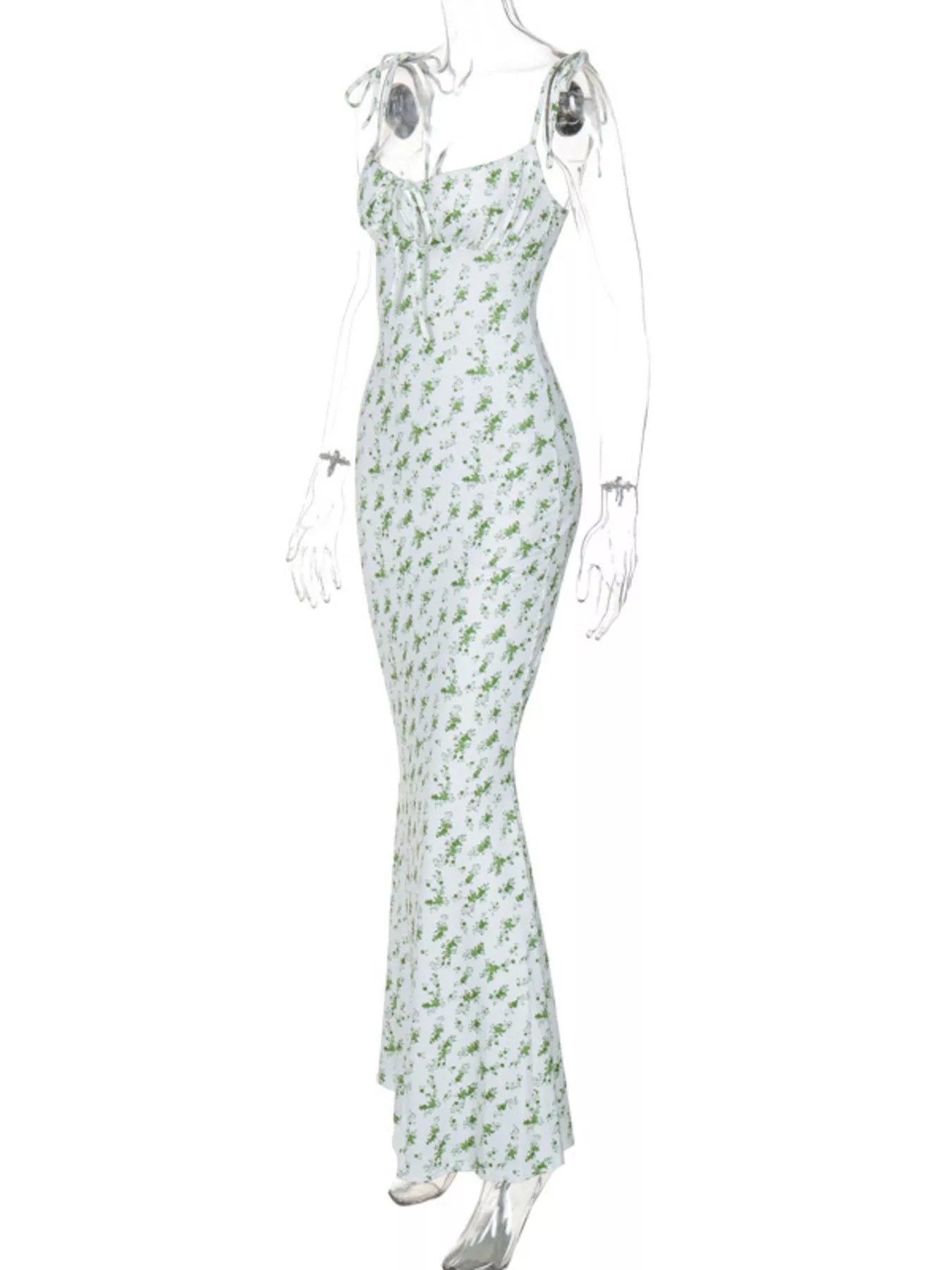 Side angle of clear mannequin wearing white and green floral print bodycon maxi dress with tie straps