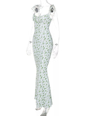 Side angle of clear mannequin wearing white and green floral print bodycon maxi dress with tie straps