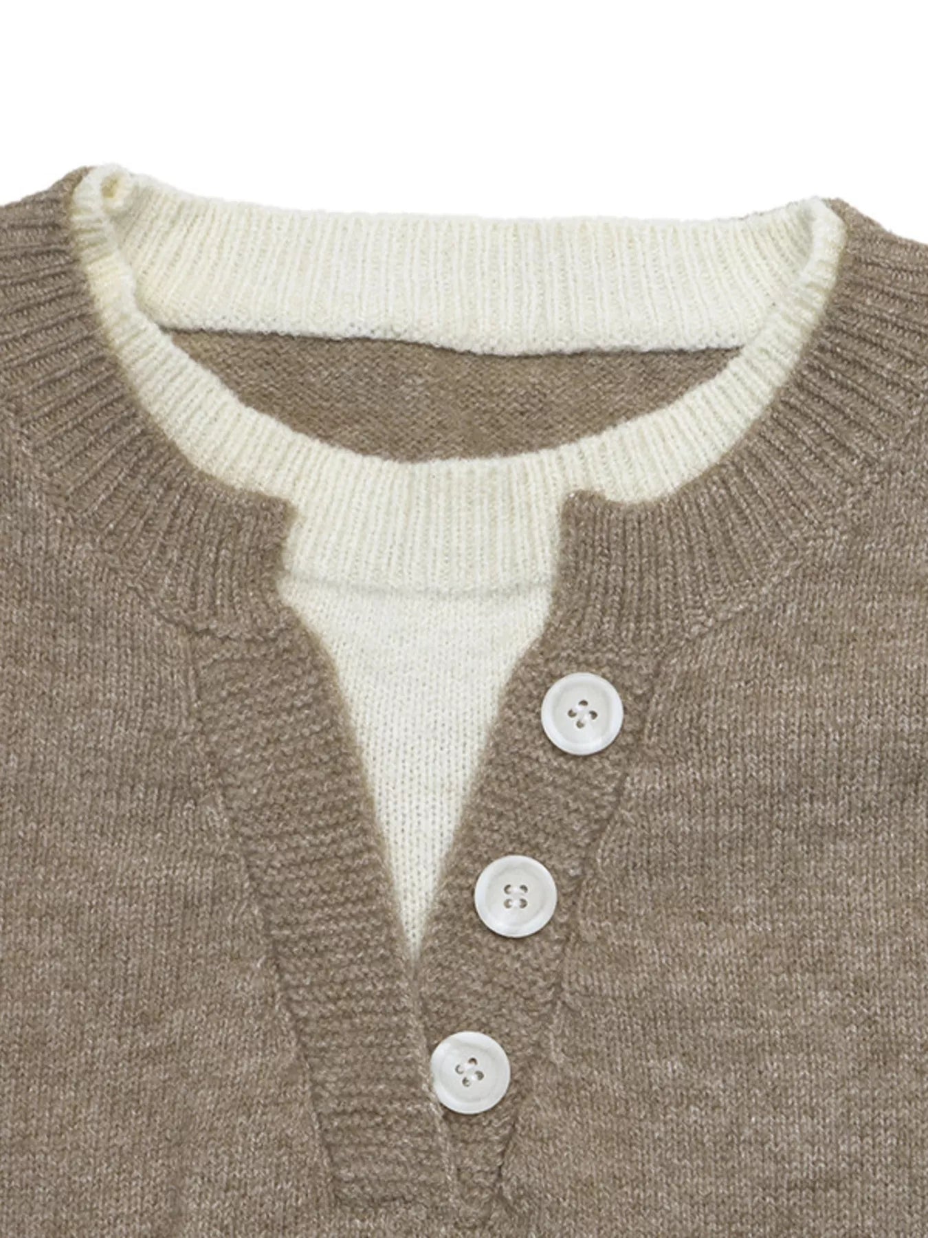 Close up of khaki sweater neckline with white layered top and white buttons