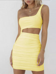 Front close view of light yellow one shoulder cutout ruched bodycon mini dress against a white wall