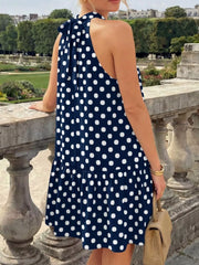 Back view of the navy blue polka dot halter neck mini dress with neck tie