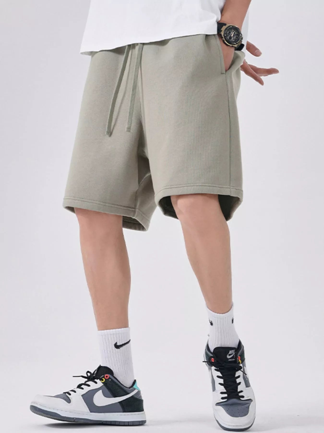 Men's sage casual shorts with a drawstring waist.