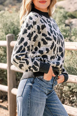 Side front view of the gray and black leopard print baggy sweater with ribbed collar, outdoors.