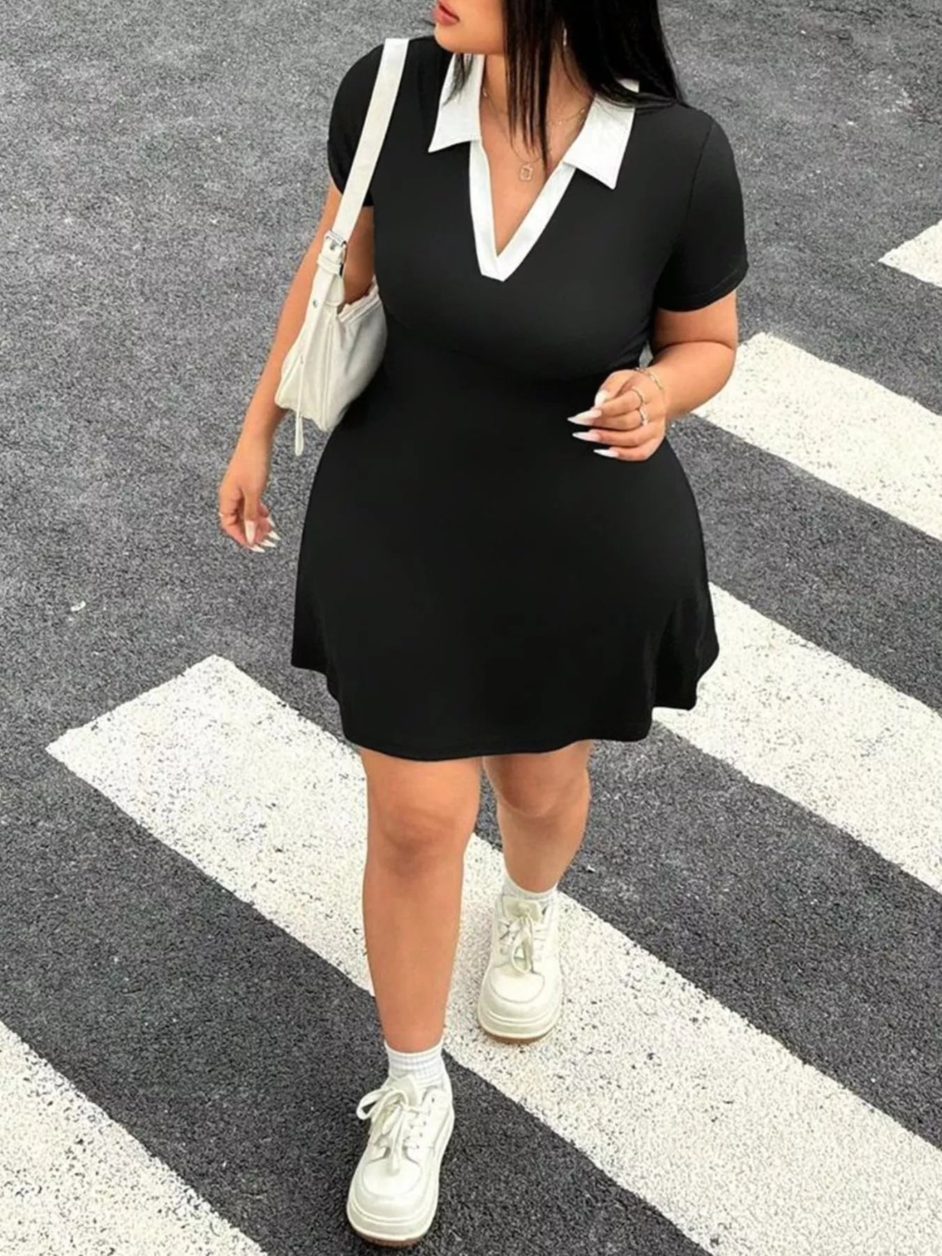 Full front view of black plus size mini dress with white contrast collar walking