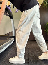 Men's light gray cotton-blend cargo pants with a drawstring waist and pockets.