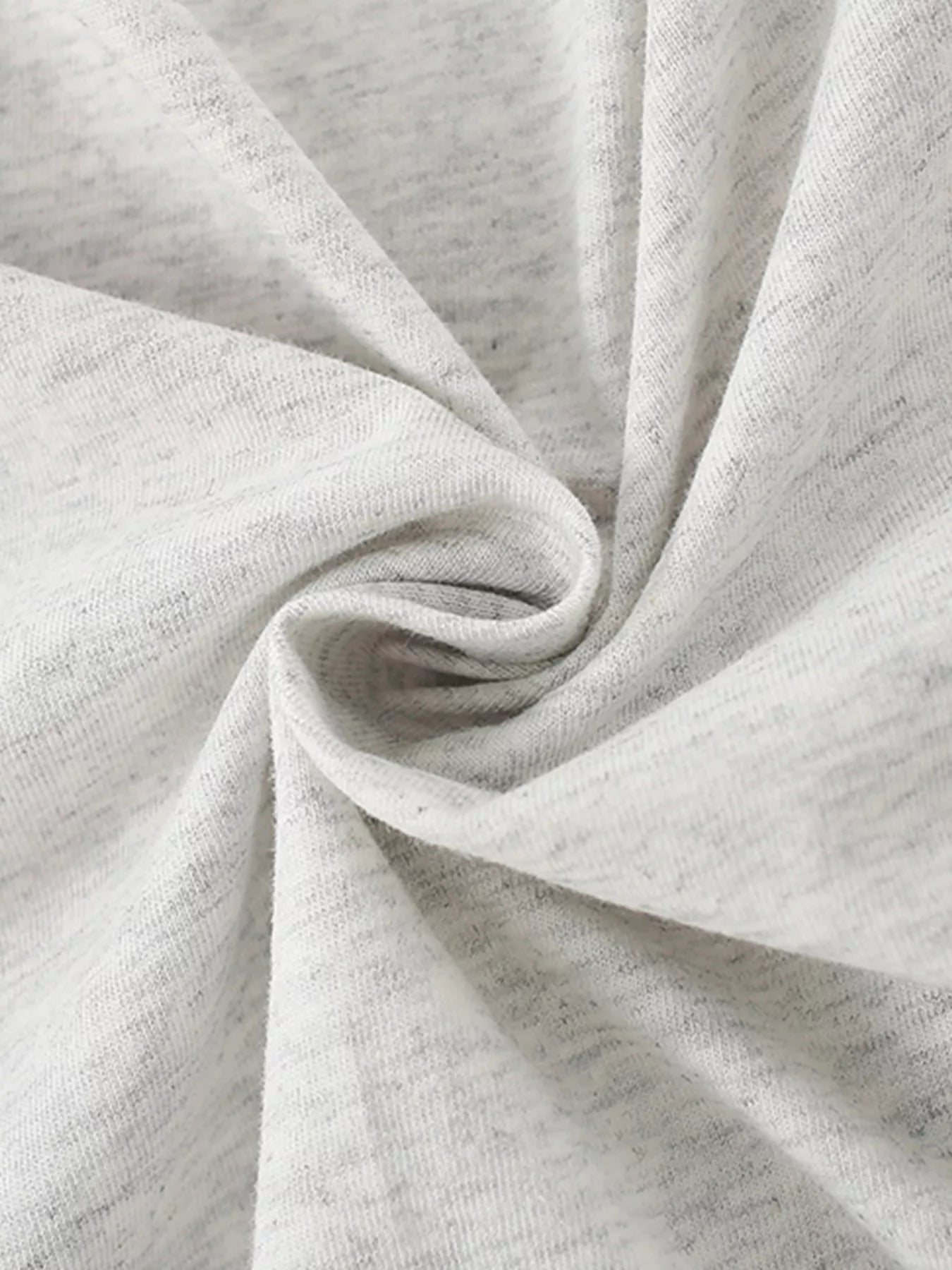 Close view of the soft twisted light gray cotton fabric texture of the children's T-shirt