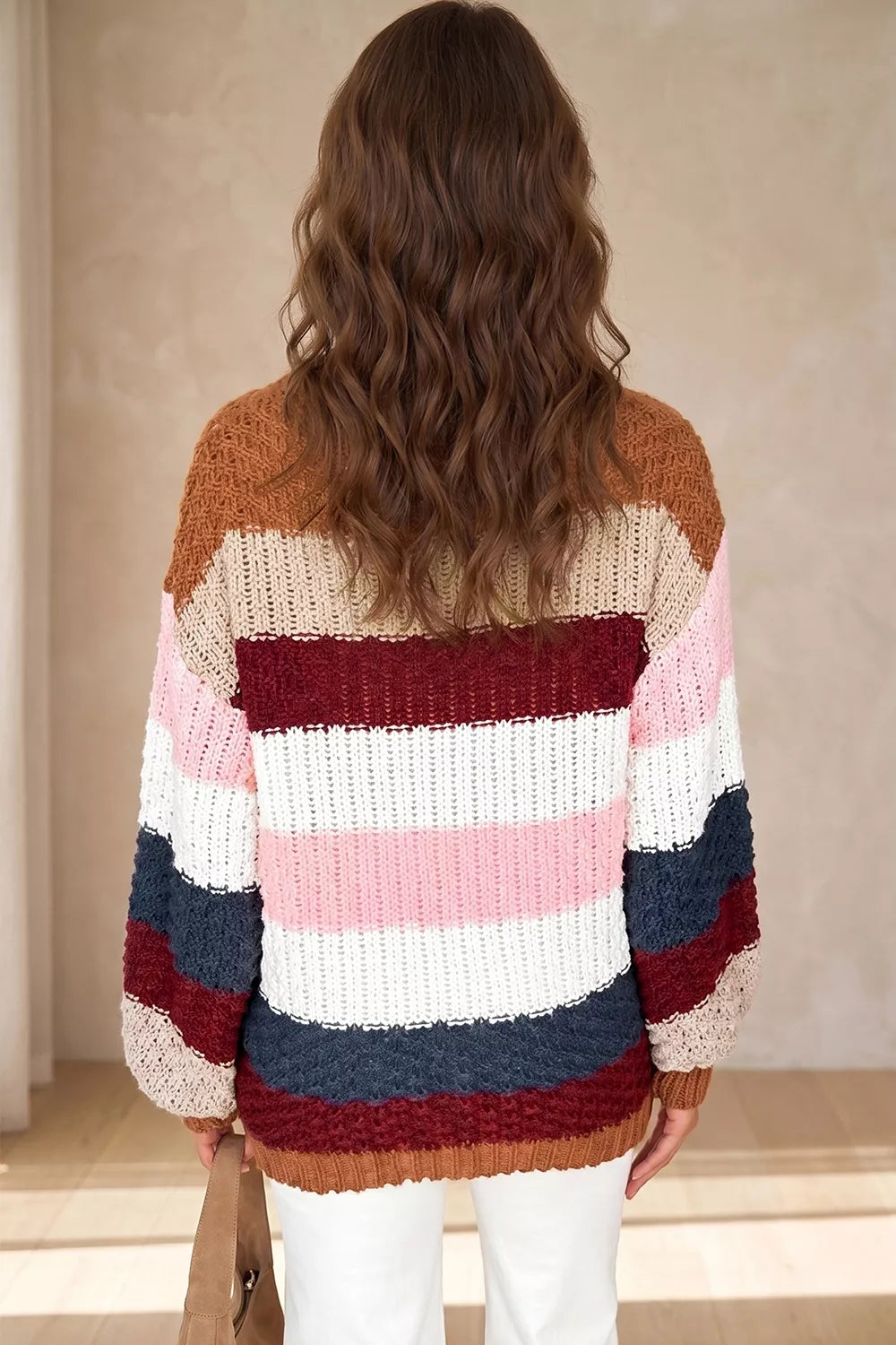 Back view of multicolor striped knit sweater with dropped shoulders and ribbed hem