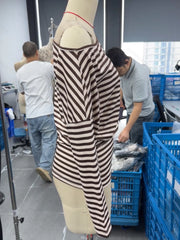 Side view of coffee brown and cream striped one shoulder long sleeve top on mannequin indoors